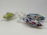 two glass fish figurines sitting next to each other on a table