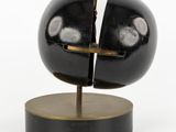 a sculpture of a black sphere on a wooden base