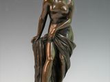 bronze statue of a man holding a bag on a marble base