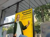 a sign in the window of a building with a picture of a man on it