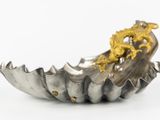 a silver bowl with a gold dragon on it