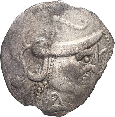 an ancient coin with a man ' s head and a hat on it