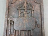 carvings of a horse and a bird on a wooden plaque