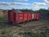 a red dump truck that is parked in the dirt