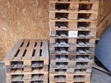 several pallets of wood are stacked on top of each other in a garage