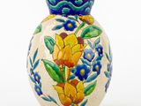 a vase with a floral design on it on a white background