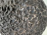 a close up of a metal object with a ball on it