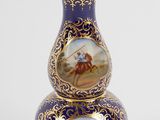 two vases with paintings on them sitting on a white surface