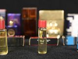 bottles of perfumes are lined up on a table with a black background