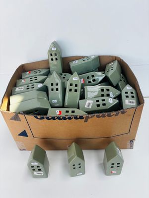 a cardboard box filled with lots of small green houses
