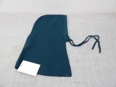 a close up of a blue knitted bag with a tag on it