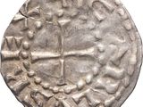 une vieille pièce d'argent ornée d'une croix
