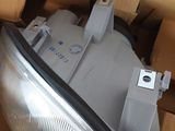the headlight of a car in a cardboard box with a box in the background