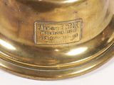 a gold clock with a bell on top of it