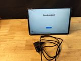 a laptop that is sitting on a table with a cord attached to it