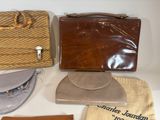 many different types of purses sitting on a table