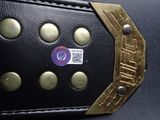 a close up of a black belt with gold buttons on it