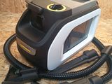 a black and white steam iron on a wooden surface