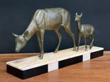 a statue of a deer and a baby deer on a table