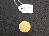 a small gold coin with a price tag on it