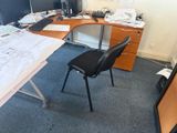 a desk with a chair and a computer on it