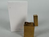 a small lighter that is sitting next to a card