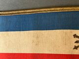 an image of a red, white and blue ribbon with a skull and crossbone on it