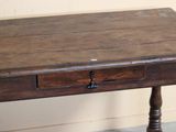 a small wooden table with a drawer on top of it