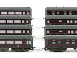 two trains that are sitting side by side on a white surface