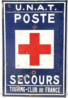 blue and white sign with a red cross on it on a white wall
