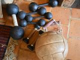 a ball, baseball bat, and other sports equipment on the floor
