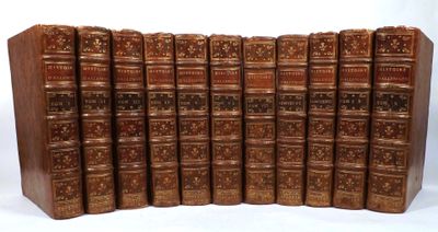 the books are lined up in a row on a white surface