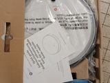 a cardboard box with a cd in it on a tiled floor