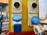 a yellow and blue fire hydrant with two blue switches on it