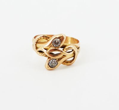 an image of a gold ring with two diamonds on it