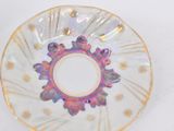 a plate with a flower design on it sitting on a table