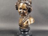 a close up of a bronze bust of a woman on a pedestal