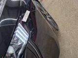 a black car parked on the side of the street