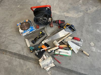 a pile of tools on the floor next to a fire hydrant