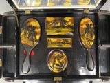 a black case with a painting on the inside of it