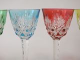four different colored wine glasses sitting next to each other on a table