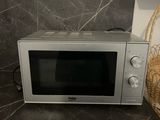 a microwave that is sitting on the counter in the kitchen