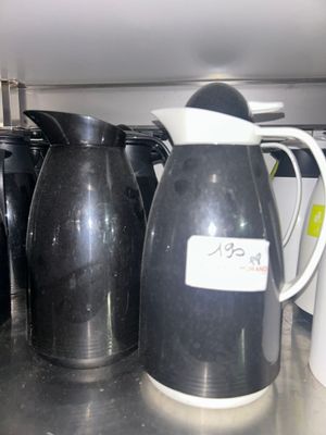 a lot of coffee pots and cups on the counter