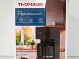 a box with a coffee maker and a cup of coffee