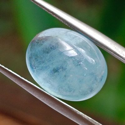 a close up of a blue stone on a wire