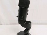 a black microphone on a stand with a white background