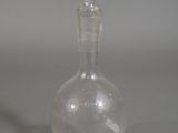 a clear glass bottle with a clear top on a table