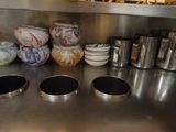 many bowls and cups on the counter in the kitchen