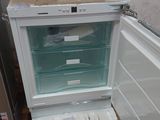 an open refrigerator and a freezer sitting on a pallet