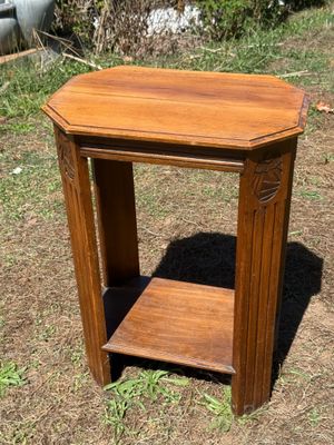 a small wooden table with a shelf on top of it